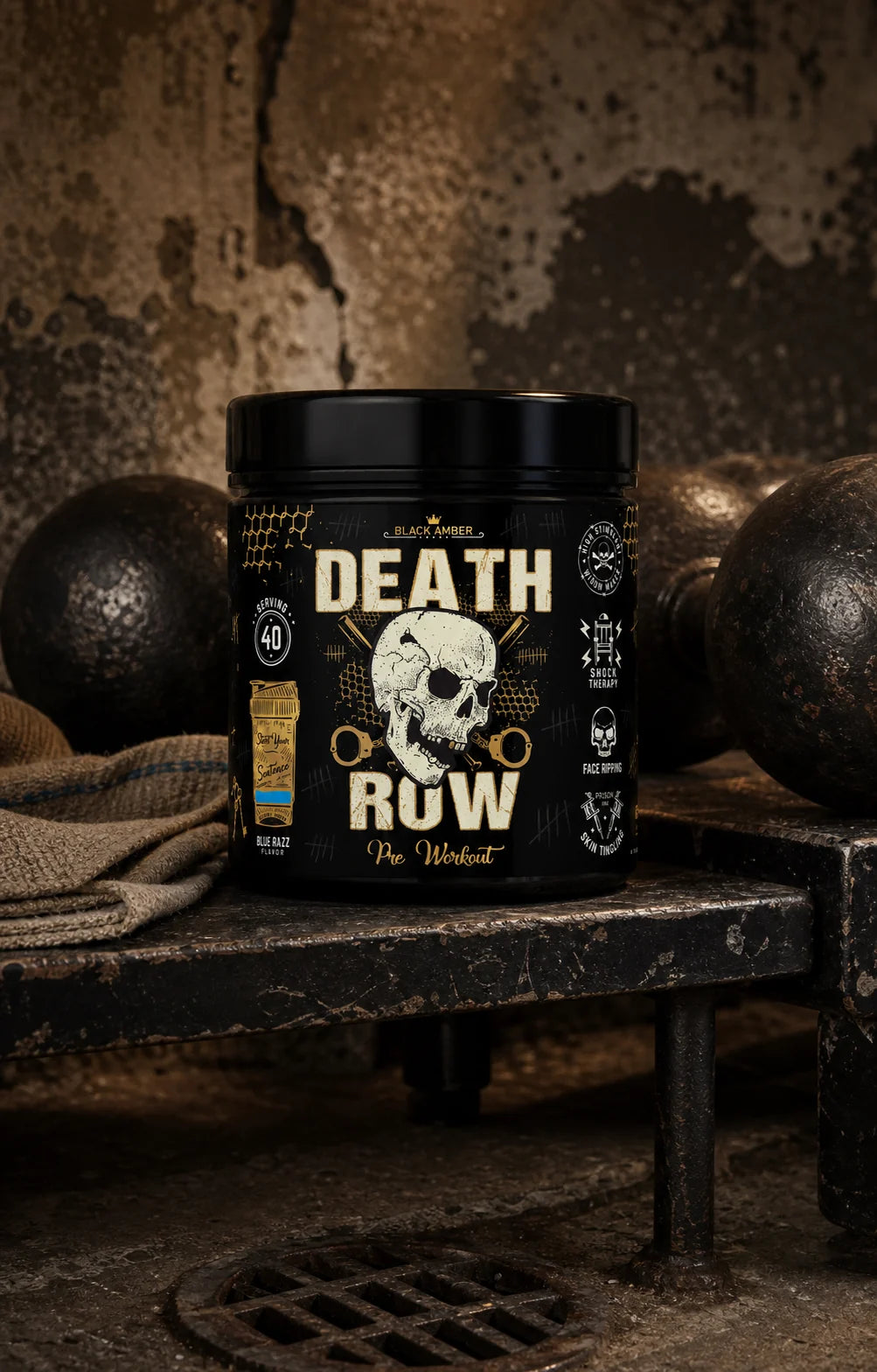 Black Amber Death Row Blue Razz pre-workout tub on a worn dumbbell rack beside a lifting strap