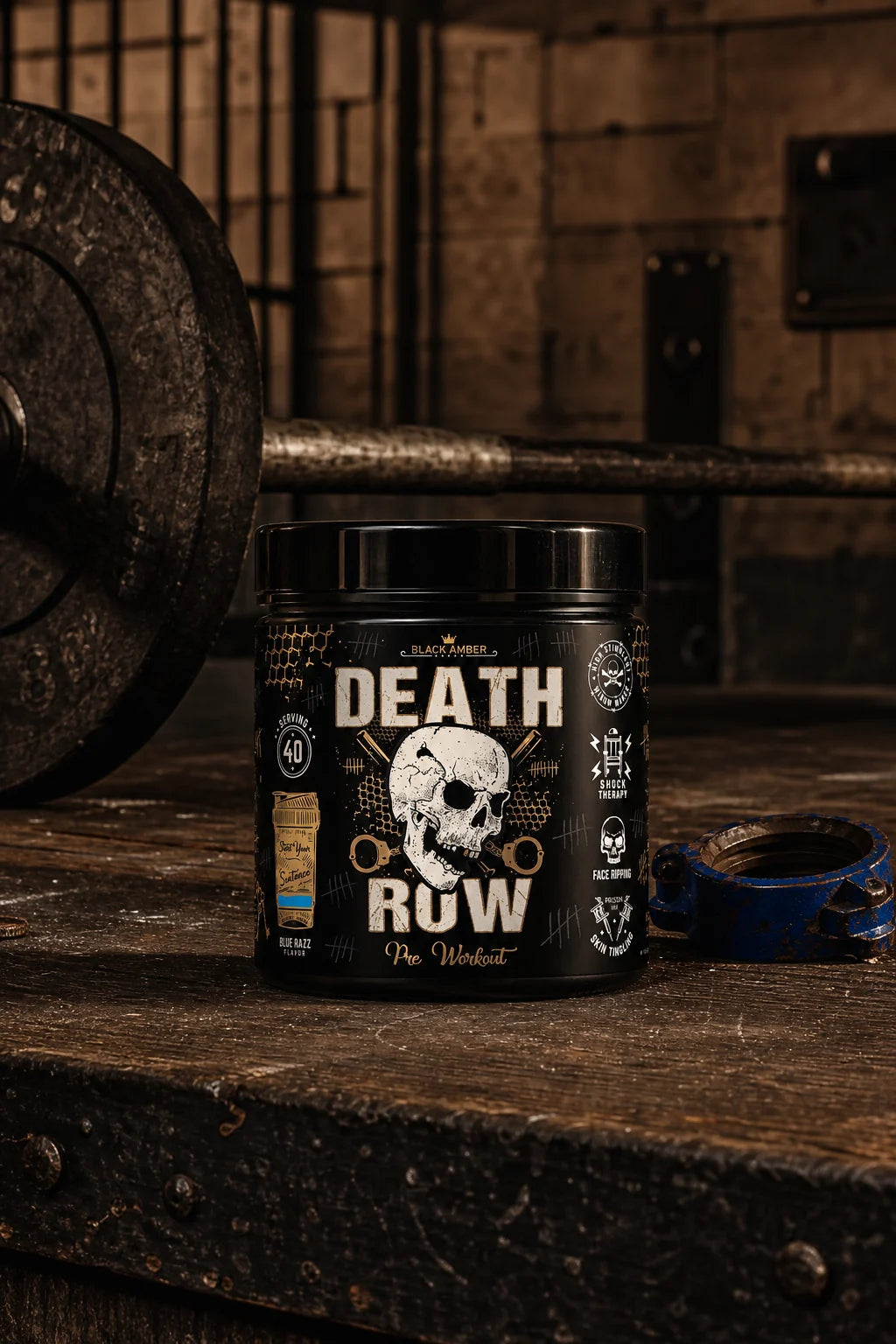 Black Amber Death Row Blue Razz pre-workout tub beside a barbell and blue collar on a worn gym platform