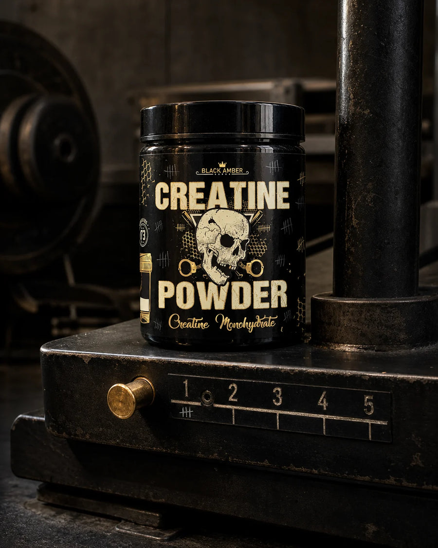 Black Amber creatine monohydrate tub on a steel training platform