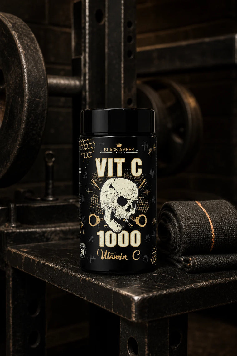 Whole Black Amber Vitamin C 1000 bottle beside a rolled lifting wrap on a steel bench