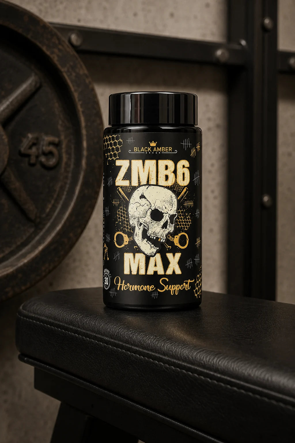 Black Amber ZMB6 Max bottle on a black padded gym bench beside a worn iron weight plate