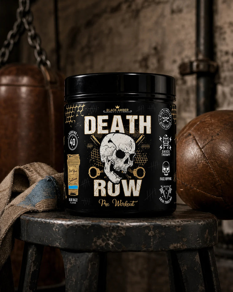 Black Amber Death Row Blue Razz pre-workout tub on a worn boxing stool beside a leather medicine ball and hand wraps