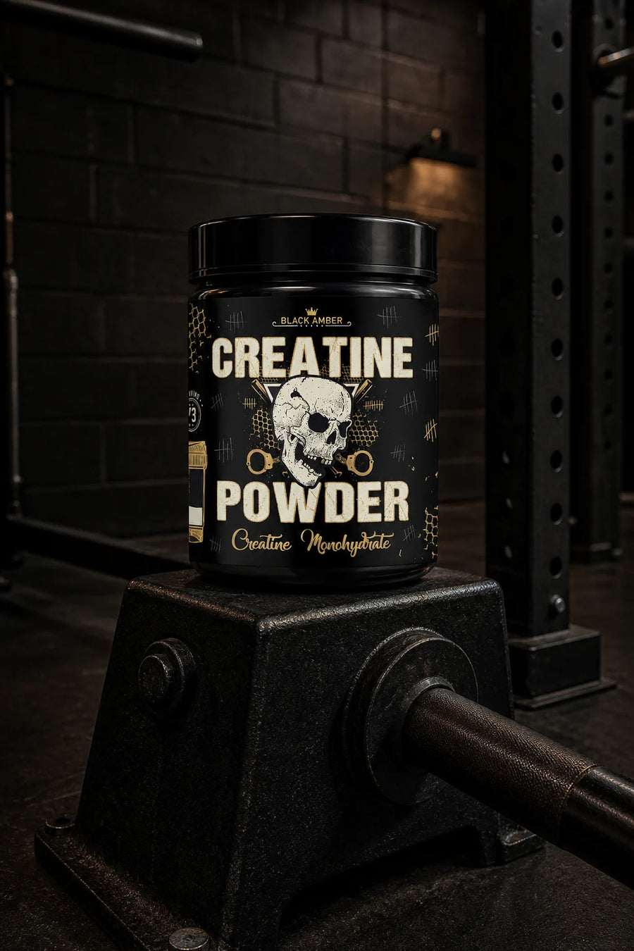 Black Amber Creatine Powder tub on a black landmine pivot block beside a squat rack