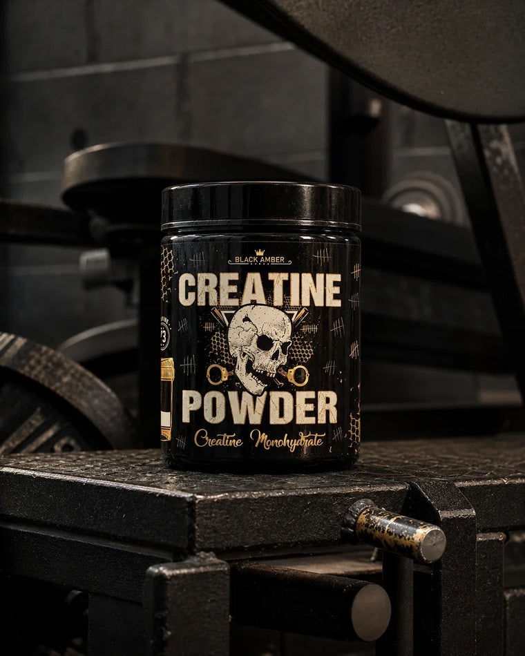 Whole Black Amber Creatine Powder tub on a worn reverse-hyper machine platform