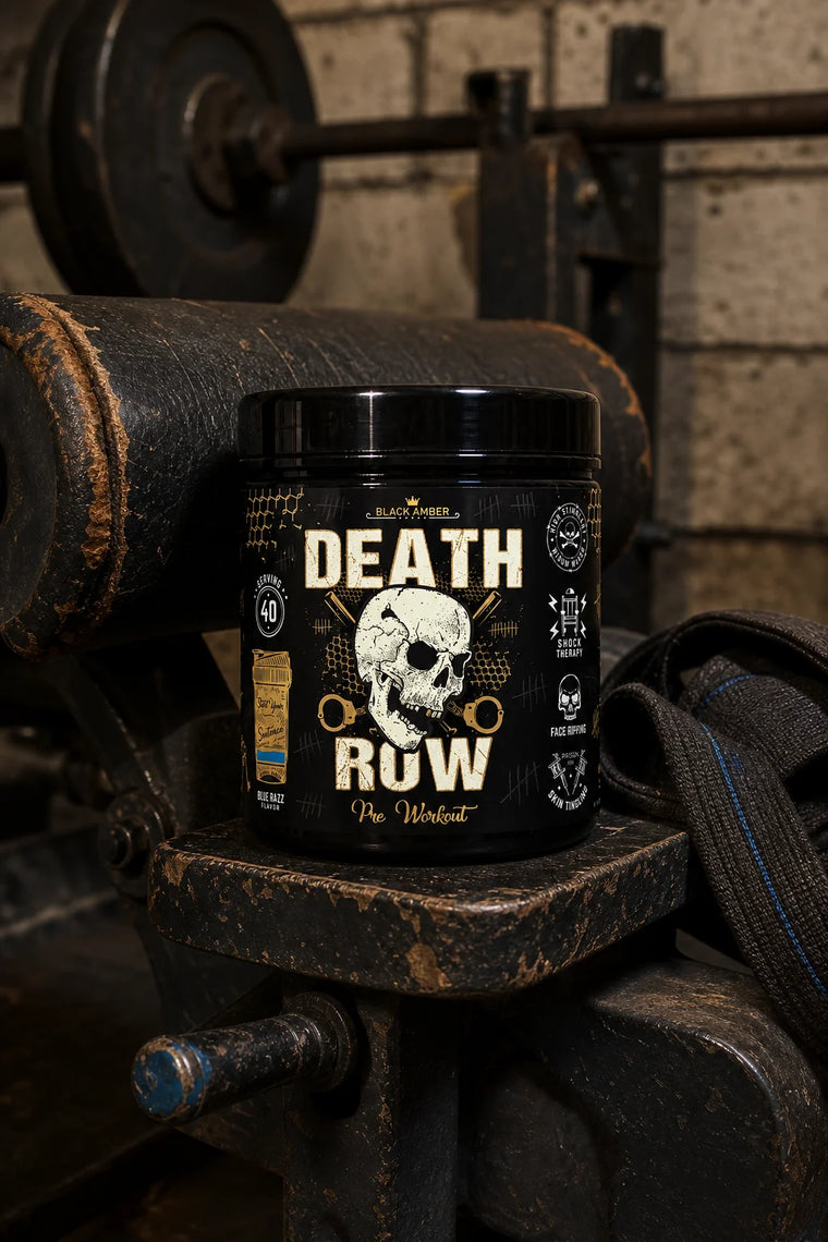Whole Black Amber Death Row Blue Razz pre-workout tub on a worn preacher-bench support beside a lifting strap