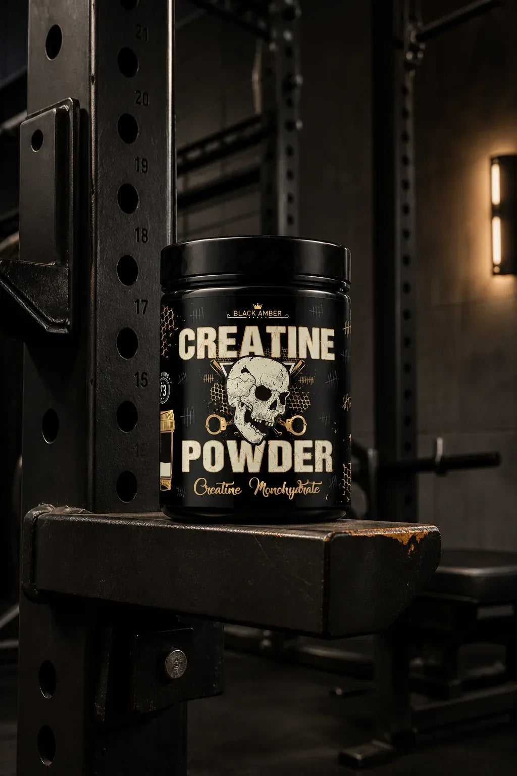 Black Amber Creatine Monohydrate tub on a squat-rack safety ledge