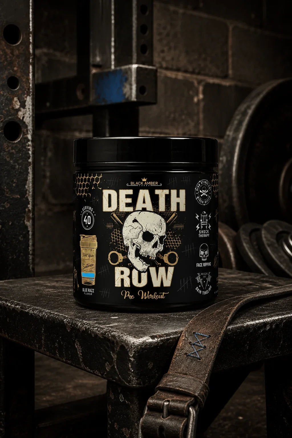 Black Amber Death Row Blue Razz pre-workout tub on a worn steel squat-rack platform beside a leather lifting belt