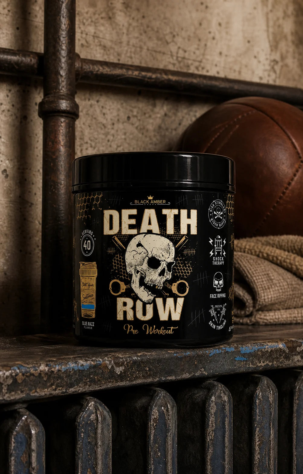 Black Amber Death Row Blue Razz pre-workout tub on a worn blue radiator shelf beside a leather medicine ball