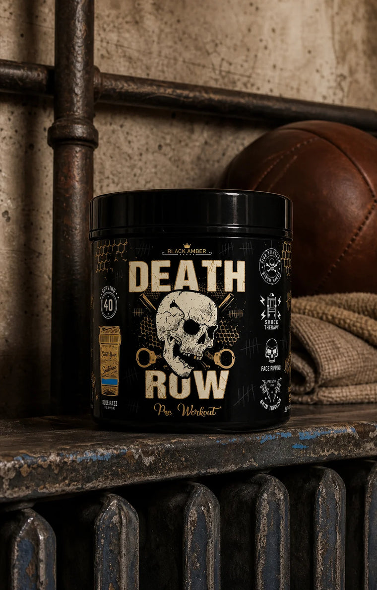 Black Amber Death Row Blue Razz pre-workout tub on a worn blue radiator shelf beside a leather medicine ball