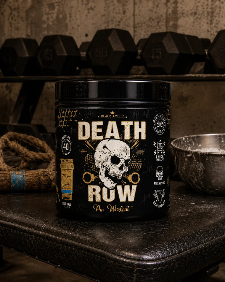 Black Amber Death Row Blue Razz pre-workout tub on a worn leather bench beside a chalk bowl and rope
