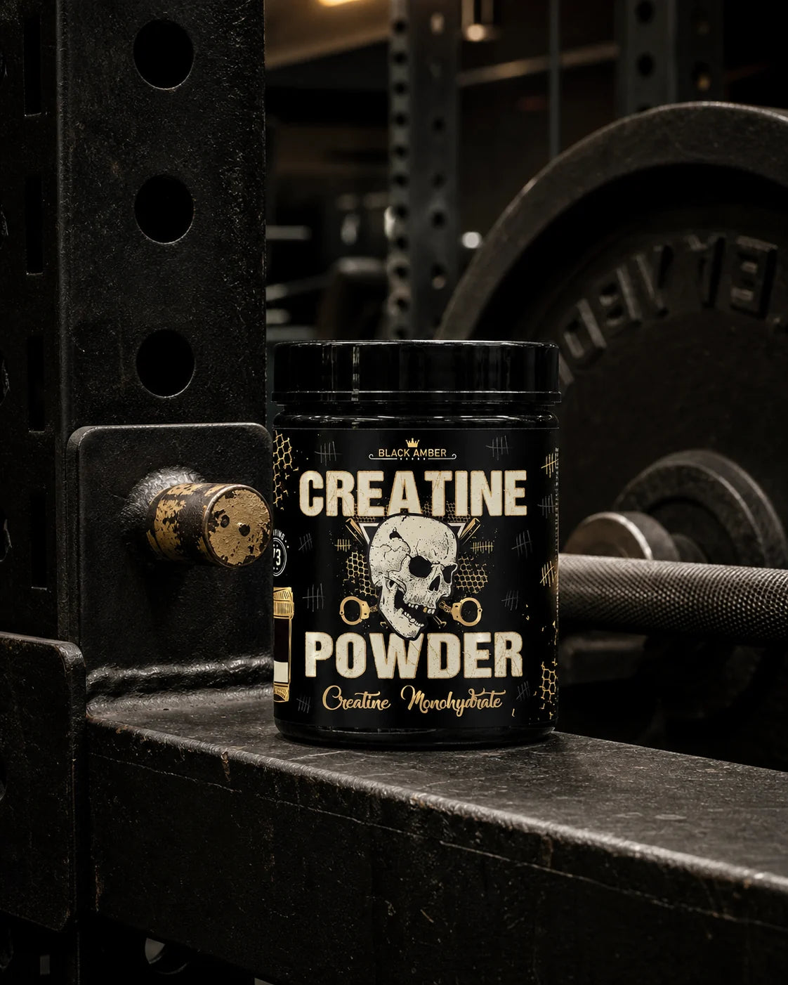 Black Amber Creatine Powder tub on a steel power-rack crossmember beside a barbell and weight plate