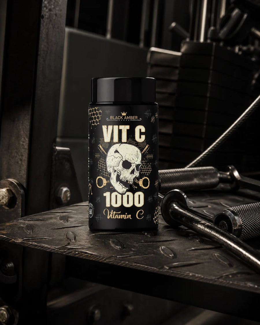 Black Amber Vitamin C 1000 bottle on a textured rowing-machine footplate beside cable handles