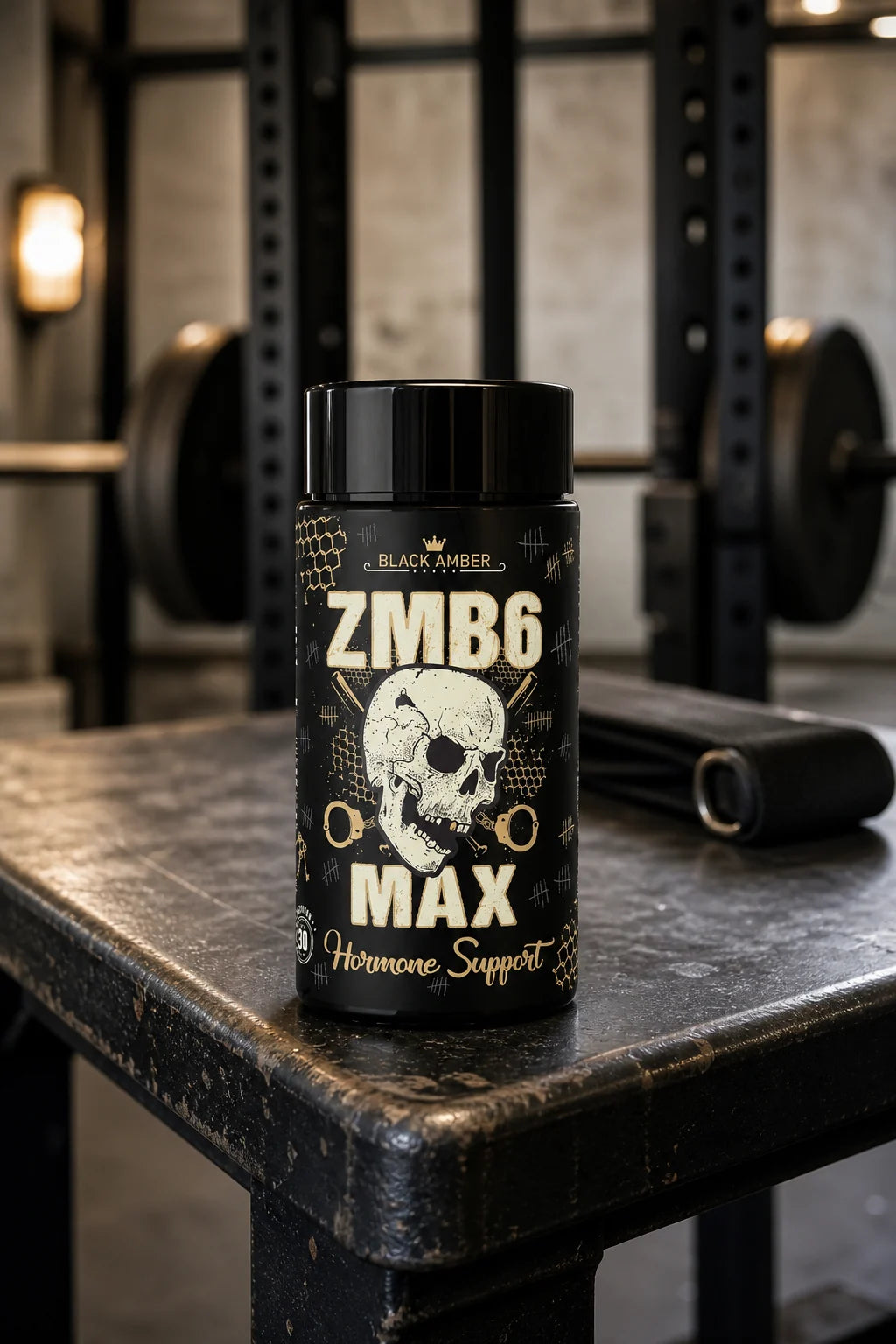 Black Amber ZMB6 Max bottle on a worn iron gym bench beside a lifting strap