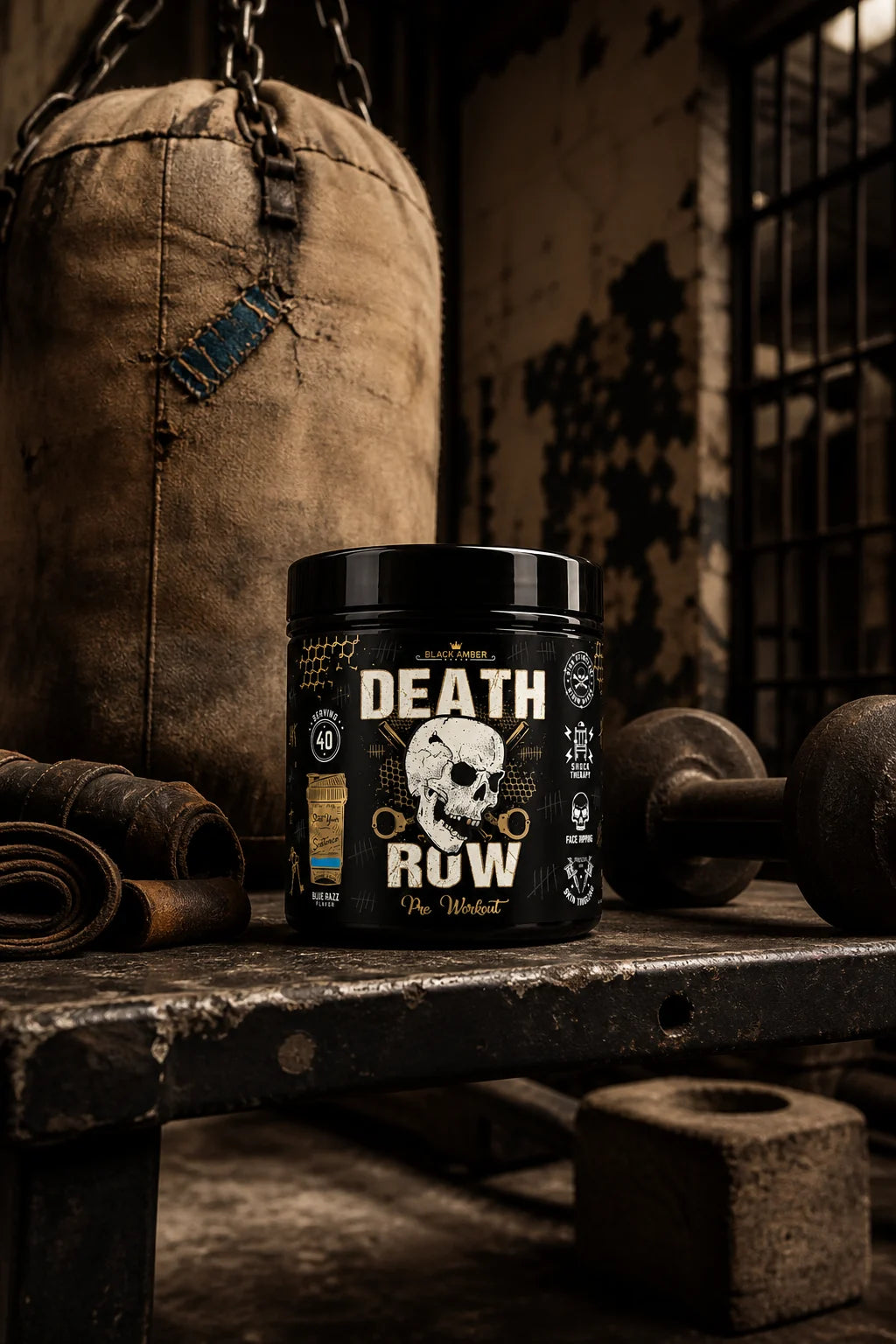 Black Amber Death Row Blue Razz pre-workout tub on a worn bench beside a heavy bag and lifting wraps