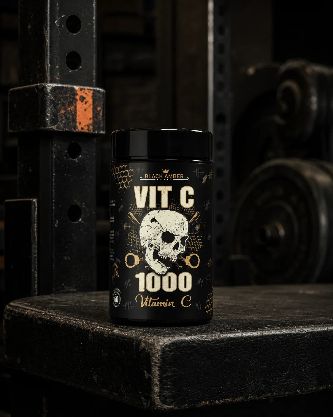 Black Amber Vitamin C 1000 capsule bottle on a worn black lifting platform beside an iron rack