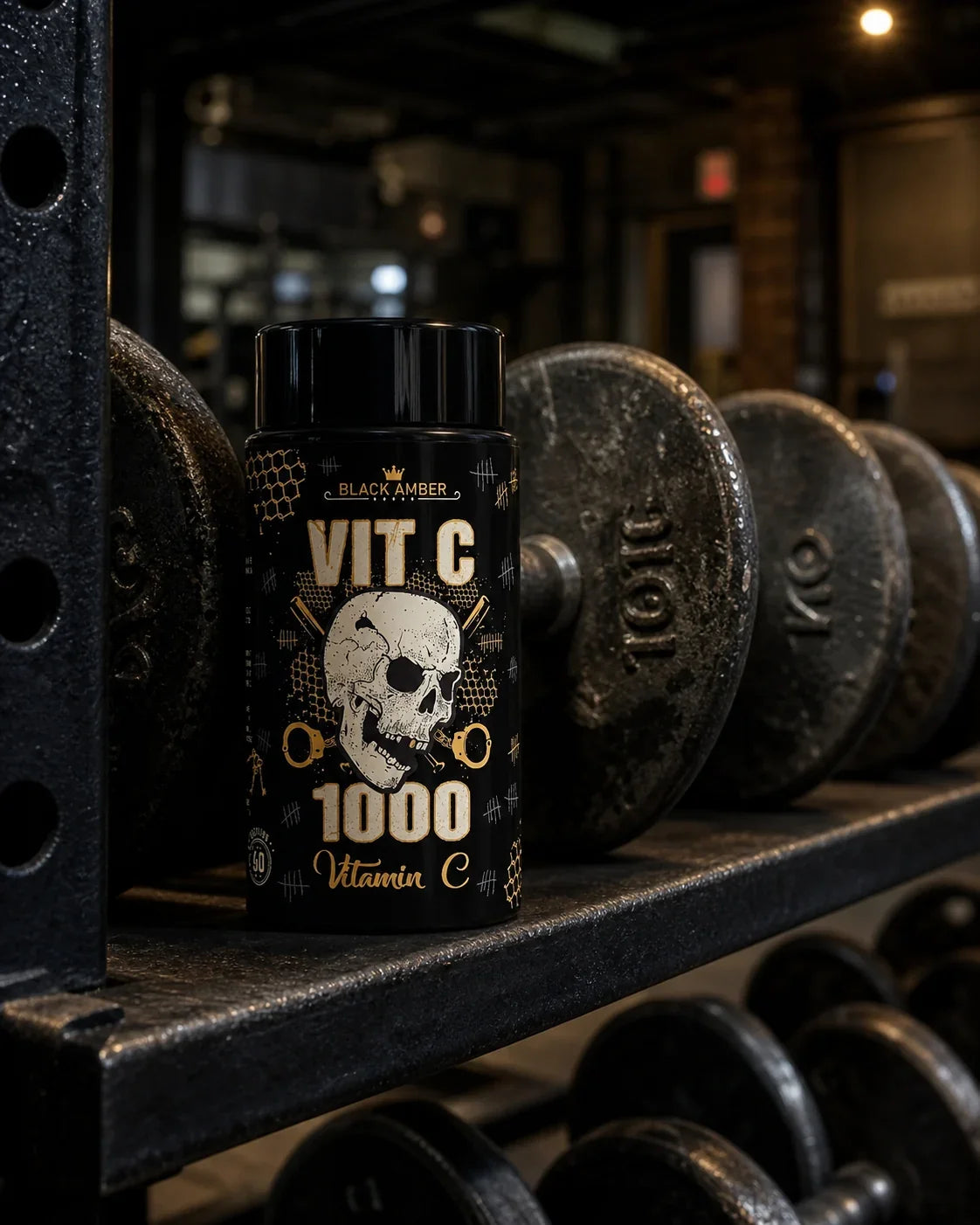 Black Amber Vitamin C 1000 bottle on a steel shelf beside worn iron dumbbells
