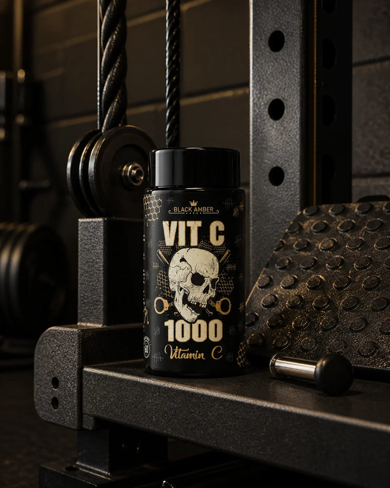 Black Amber Vitamin C 1000 bottle on a cable-machine shelf beside a pulley and selector pin