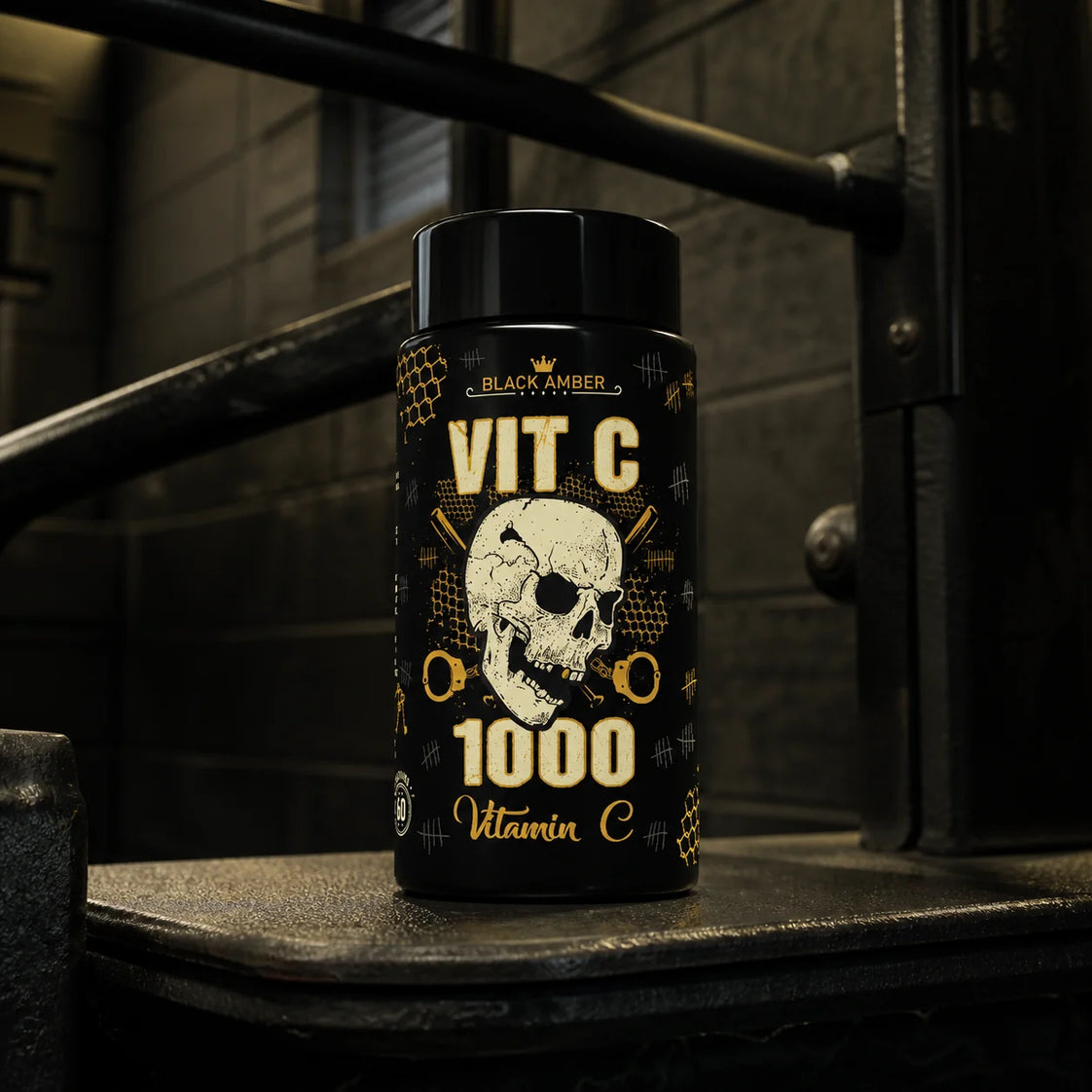 Black Amber Vitamin C 1000 bottle on a worn dip-station step in a dark industrial gym