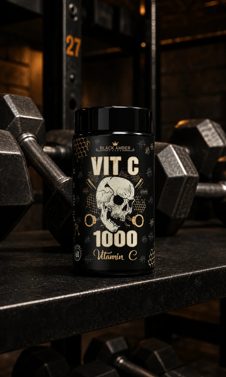 Black Amber Vitamin C 1000 bottle on a worn steel dumbbell shelf in a dark gym