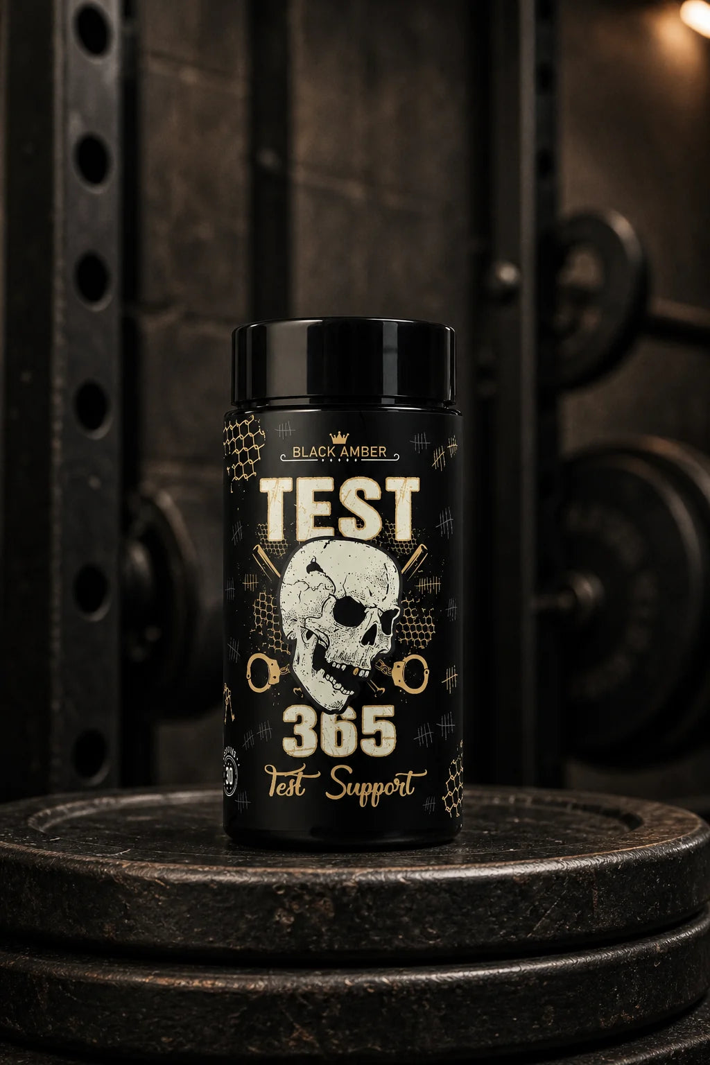 Black Amber Test 365 bottle standing on worn iron weight plates beside a gym rack