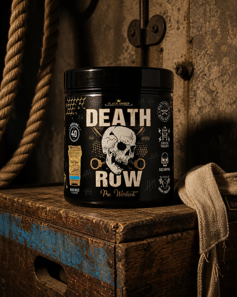 Black Amber Death Row Blue Razz pre-workout tub on a worn wooden vault box beside a climbing rope